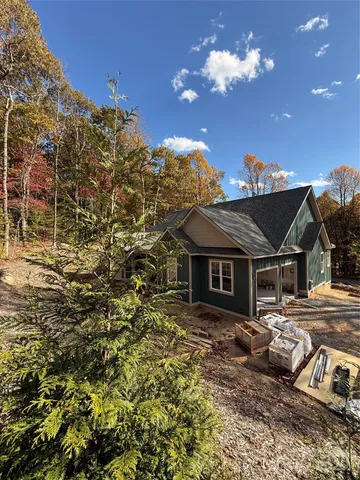 a view of house with backyard