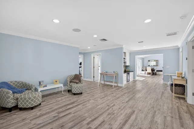 a living room with furniture ceiling fan and a wooden floor