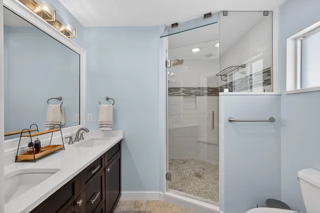 a bathroom with a toilet and a shower