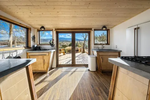 a view of a chairs and table in the balcony