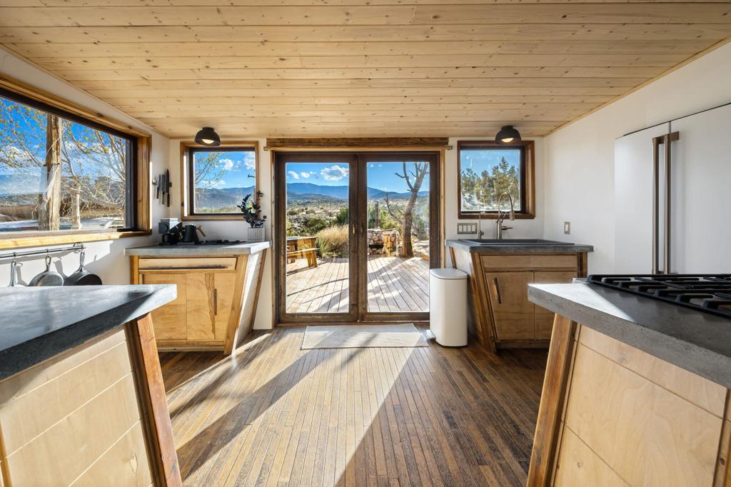 1102 Burlington Road Pioneertown, CA 92268 - Photo 19 of 68 a kitchen with a stove a sink a counter top space and cabinets