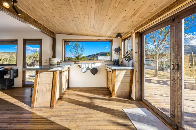 a room with wooden floor and outdoor view