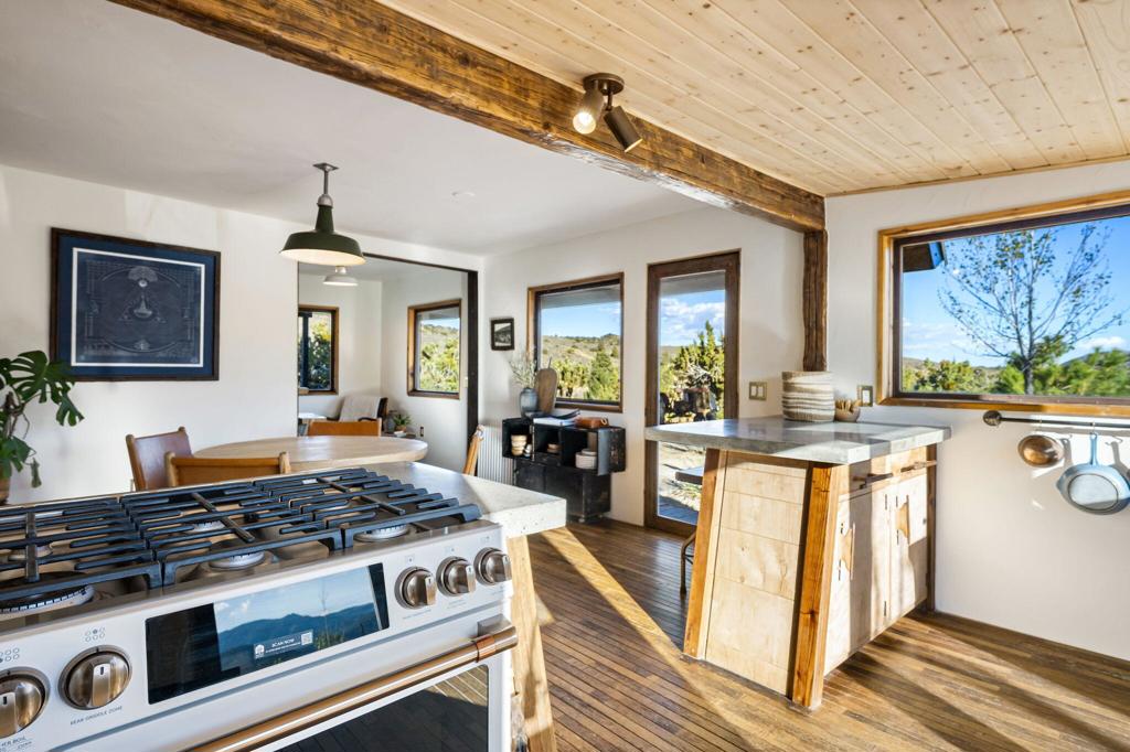 1102 Burlington Road Pioneertown, CA 92268 - Photo 22 of 68 a kitchen with stainless steel appliances granite countertop a stove and a refrigerator