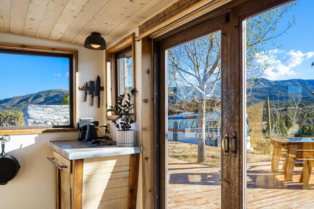 1102 Burlington Road Pioneertown, CA 92268 - Photo 23 of 68 a view of a kitchen with a sink and dishwasher next to a yard