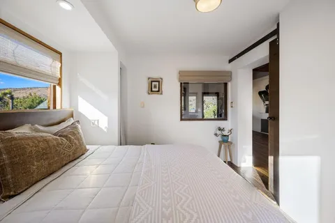 a bedroom with furniture and a window