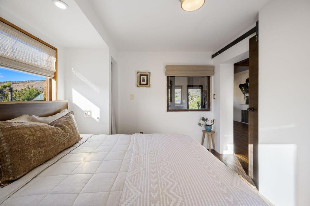 1102 Burlington Road Pioneertown, CA 92268 - Photo 33 of 68 a bedroom with a bed and a window