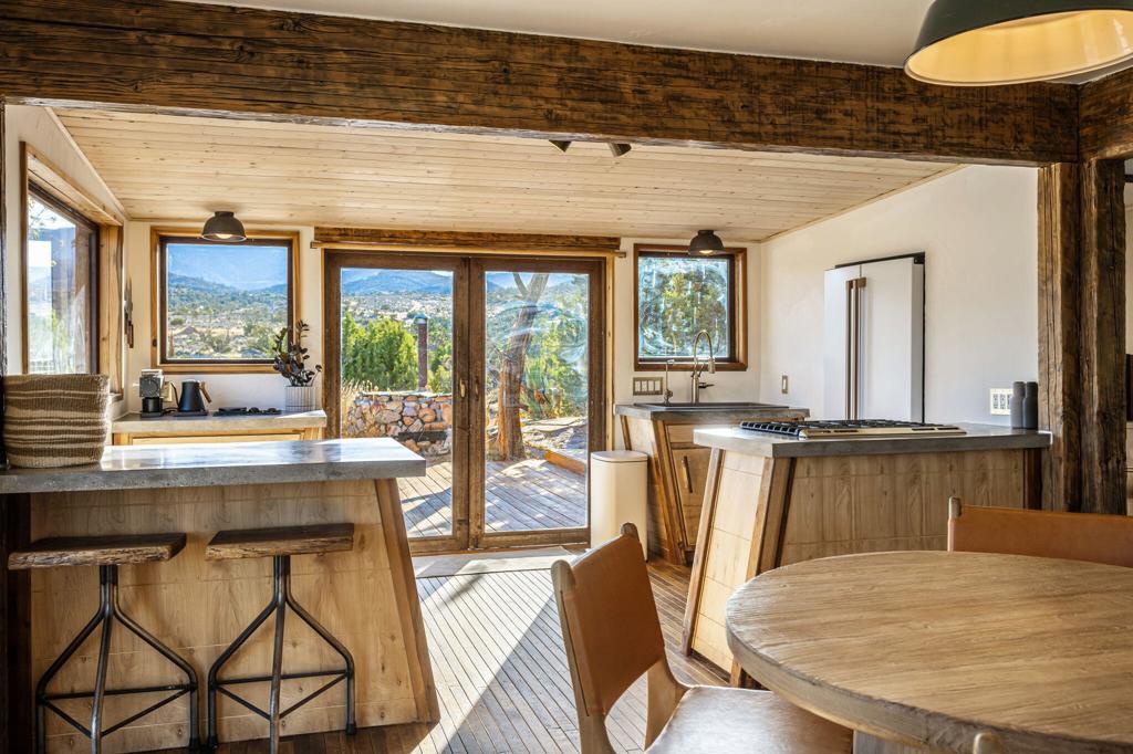 1102 Burlington Road Pioneertown, CA 92268 - Photo 40 of 68 a view of a dining room with furniture large windows and wooden floor