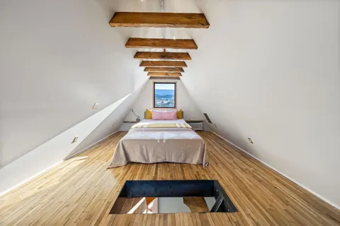 a view of a balcony with chairs and table