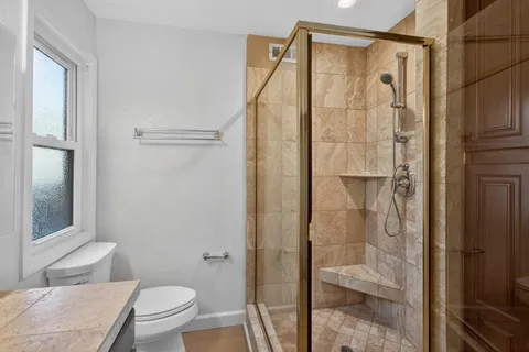 a bathroom with a shower and a toilet