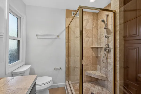 a bathroom with a shower and a toilet
