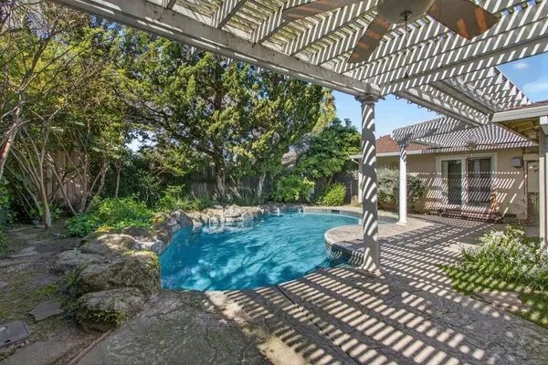 a view of a patio with table and chairs with wooden floor and fence