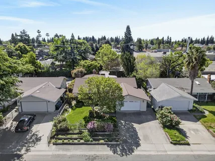 an aerial view of a house with a yard basket ball court and outdoor seating