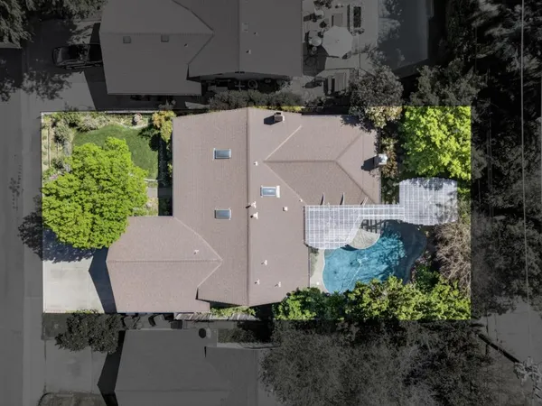 an aerial view of a house with yard and outdoor seating