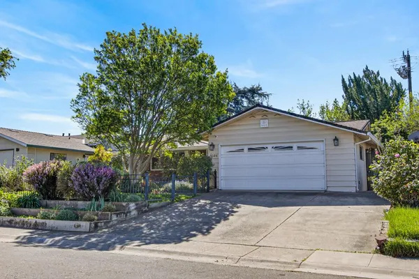 a front view of a house with a garden