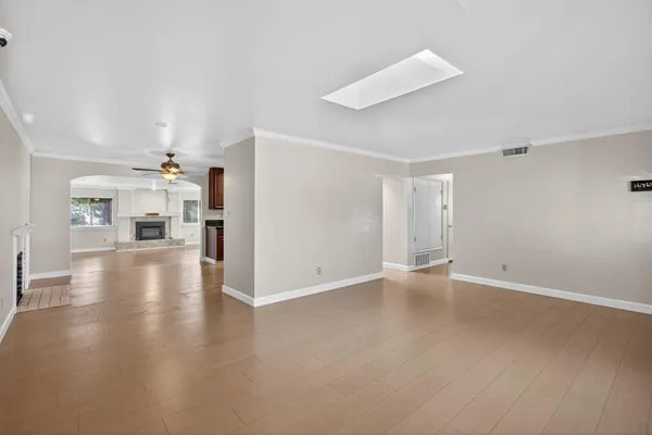 a view of a livingroom with a furniture wooden floor and a ceiling fan