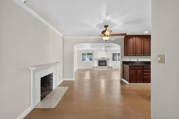 a view of a kitchen with a sink a fireplace and a window