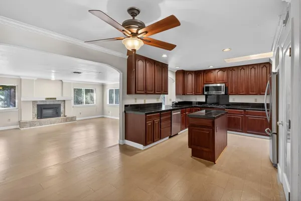 a kitchen with granite countertop stainless steel appliances and wooden cabinets