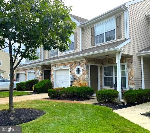 a front view of a house with a yard and porch