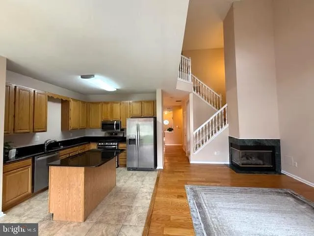 a kitchen with granite countertop a stove and a refrigerator