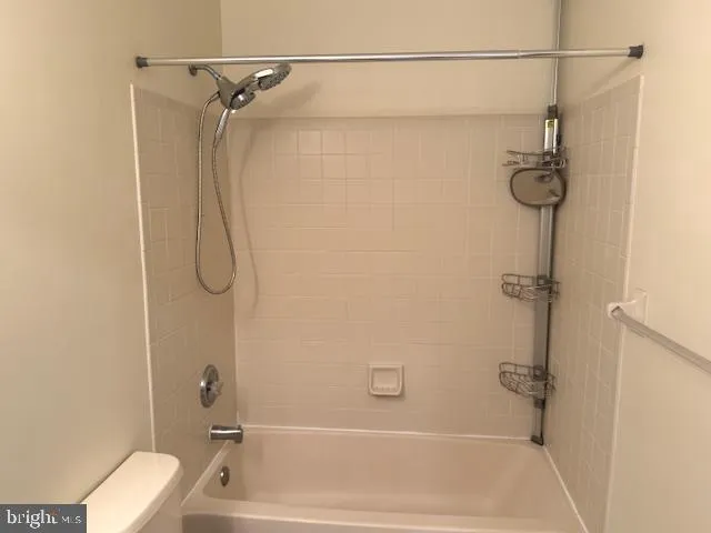 a bathroom with a bath tub with a shower