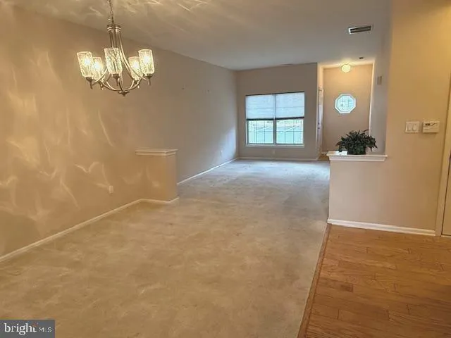 a view of livingroom with windows and chandelier