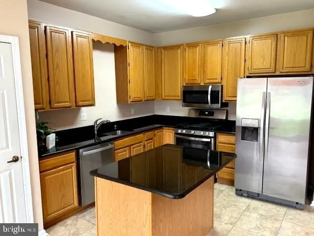 a kitchen with a sink a stove and a refrigerator