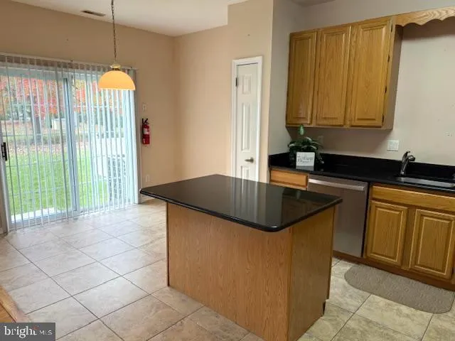 a kitchen with granite countertop a sink a stove and cabinets