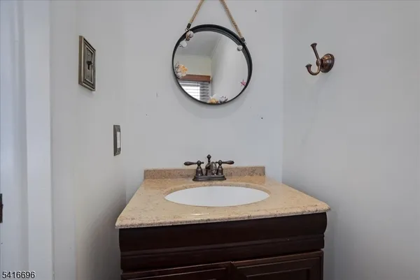 a sink sitting next to a bathroom and a mirror