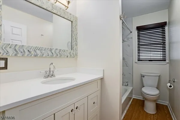 a bathroom with a sink a toilet and mirror