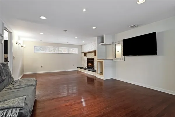 a living room with a flat screen tv and a fireplace