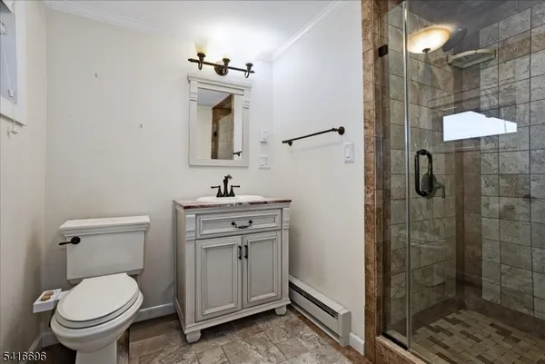 a bathroom with a toilet sink and shower