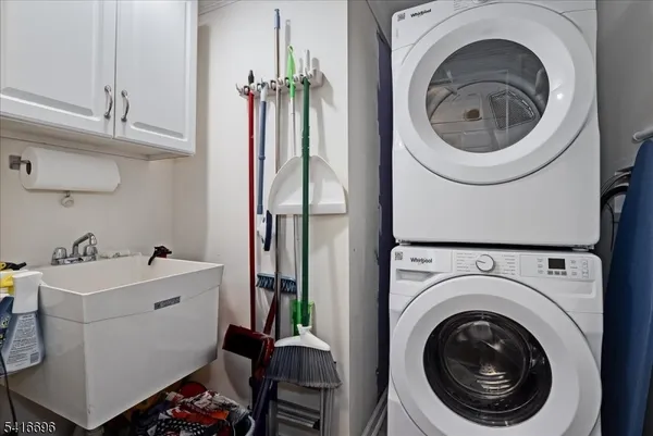 a view of a storage and utility room with washer and dryer