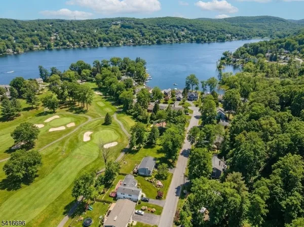 an aerial view of a houses with a lake view