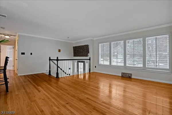 a view of a room with wooden floor and a window