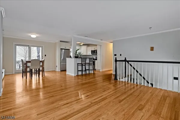 a view of dining room with furniture and wooden floor