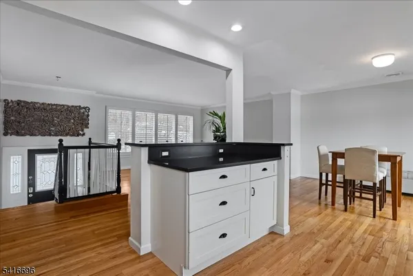 a kitchen with a table chairs and wooden floor