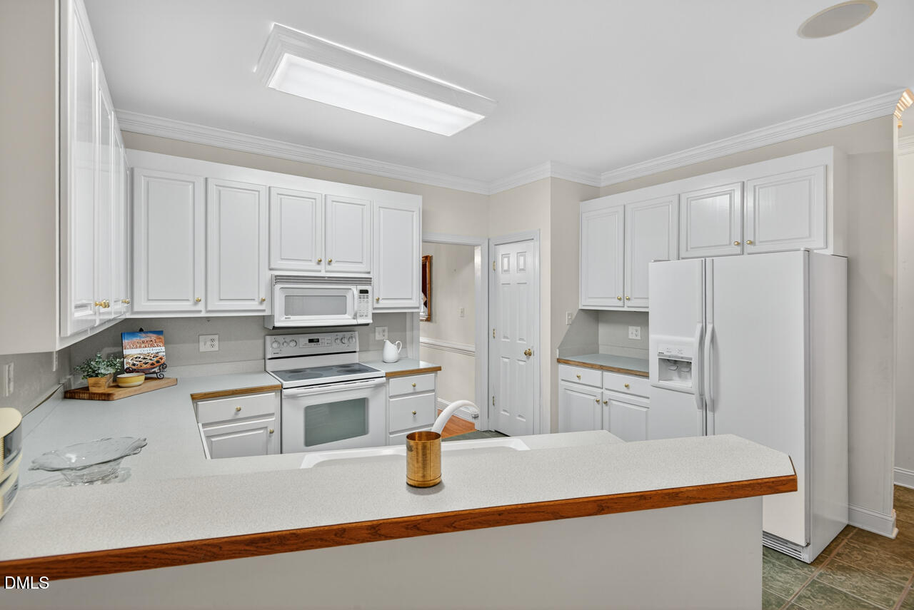 2204 Hayfield Drive Durham, NC 27705 - Photo 17 of 56 a kitchen with stainless steel appliances granite countertop a refrigerator a stove and a sink