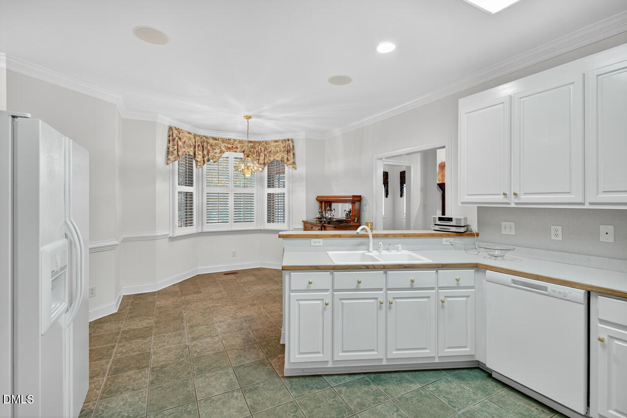 2204 Hayfield Drive Durham, NC 27705 - Photo 19 of 56 a kitchen with white cabinets and sink