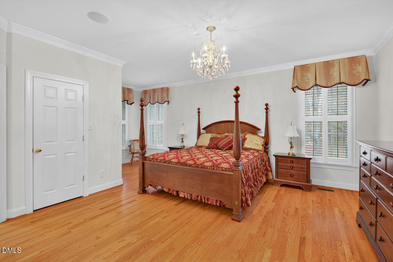 2204 Hayfield Drive Durham, NC 27705 - Photo 23 of 56 a bedroom with a bed and a dresser