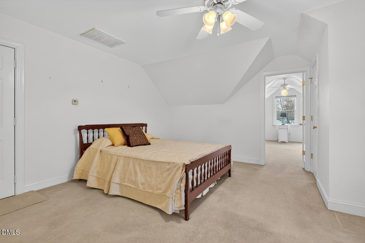 2204 Hayfield Drive Durham, NC 27705 - Photo 33 of 56 a bedroom with a bed and a chandelier