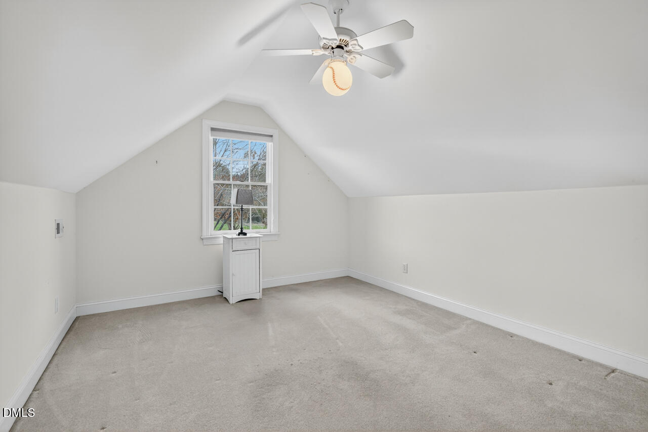 2204 Hayfield Drive Durham, NC 27705 - Photo 37 of 56 an empty room with chandelier fan and windows