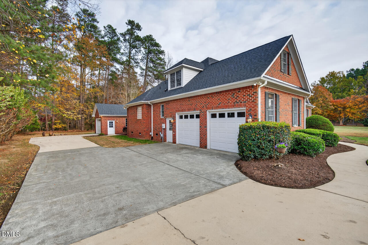 2204 Hayfield Drive Durham, NC 27705 - Photo 43 of 56 a front view of a house with a yard and garage