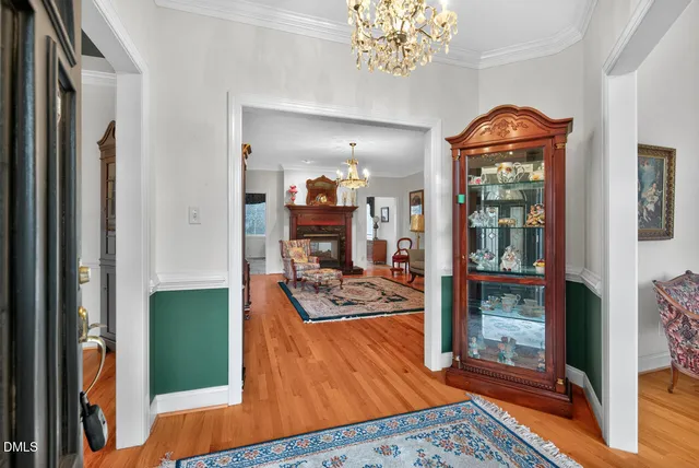 a view of a dining room with furniture and chandelier