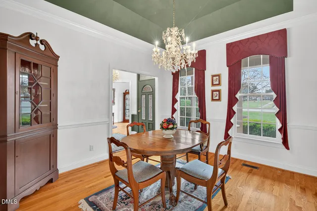 a dining room with furniture and chandelier
