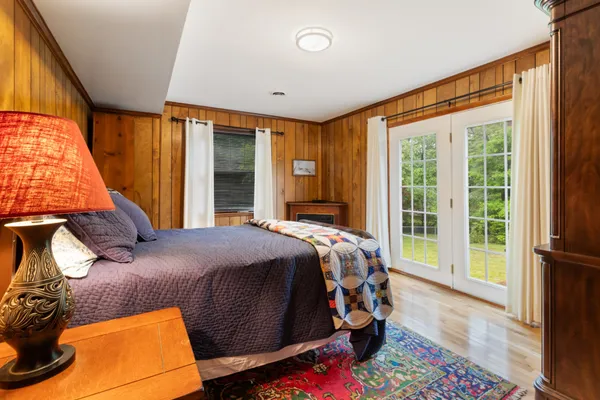 a bed sitting in a bedroom next to a window