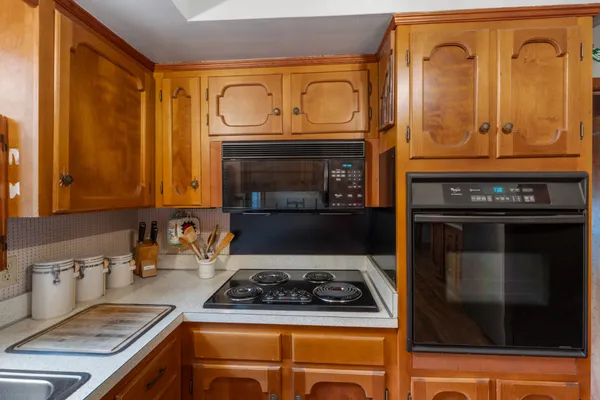 a stove top oven sitting inside of a kitchen
