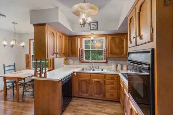 a kitchen with a sink stove and microwave