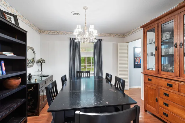 a view of a dining room with furniture and chandelier
