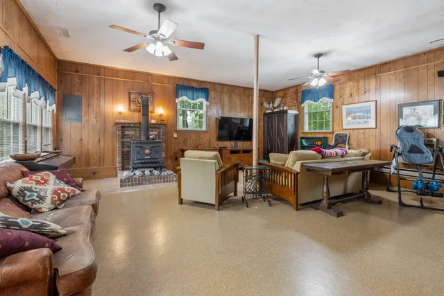 a living room with furniture gym equipment and a chandelier