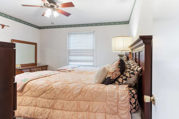 a bedroom with a bed and a chandelier
